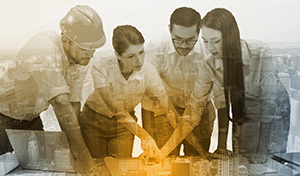 Composite image of architecture team working together at desk Composite image of architecture team working together at desk